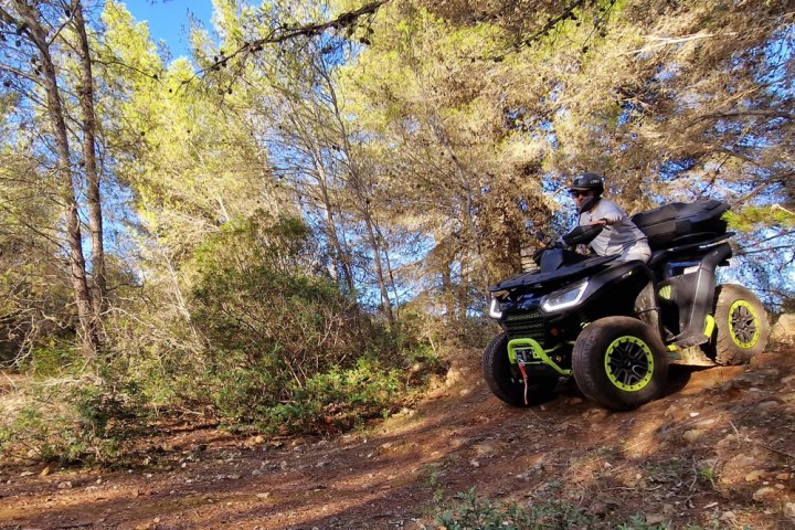 a motorcycle parked on the side of a dirt field