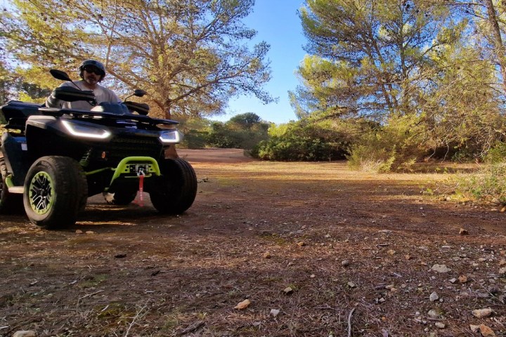 a man riding a motorcycle down a dirt road