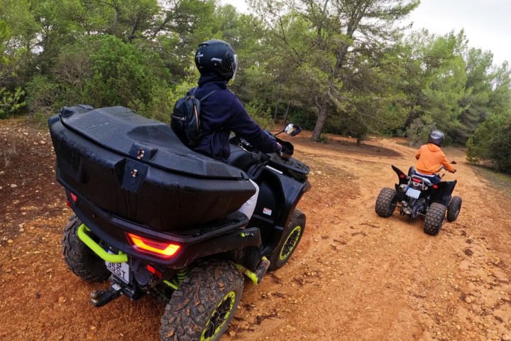 a man riding a motorcycle down a dirt road