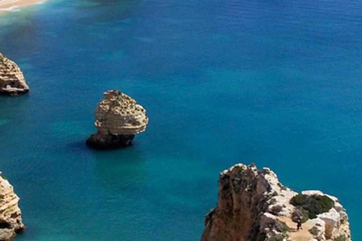 a rocky island in the middle of a body of water