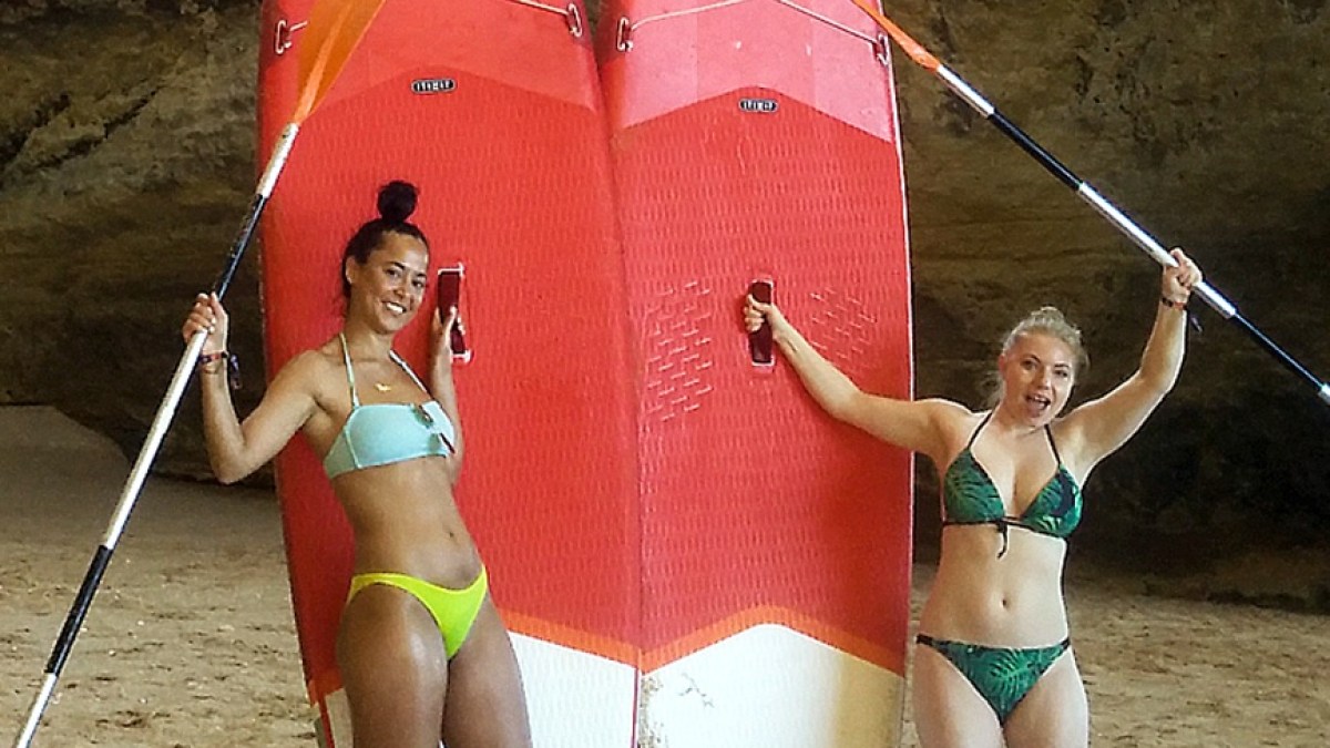 a group of people on a beach posing for the camera