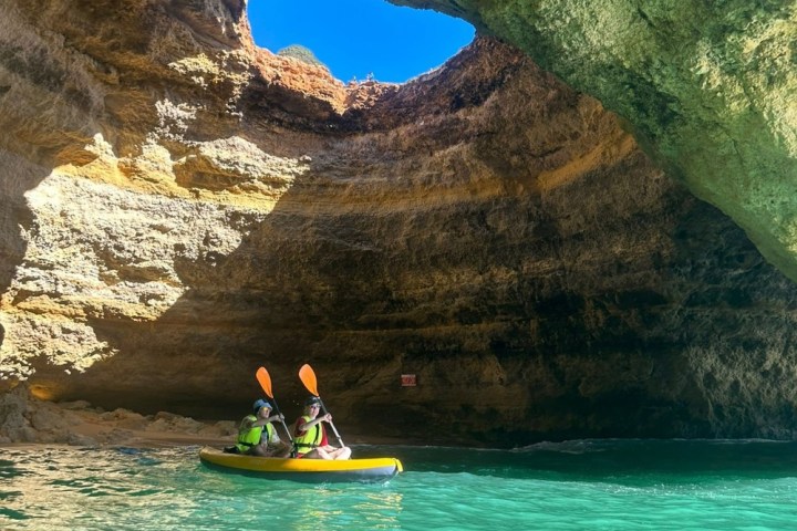 a person sitting on a rock next to water